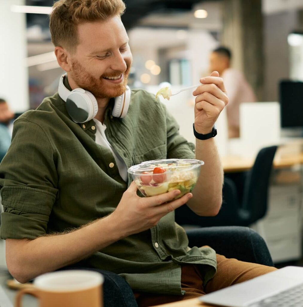 happy-businessman-eating-salad-on-lunch-break-in-t-2023-11-27-05-21-11-utc (1)