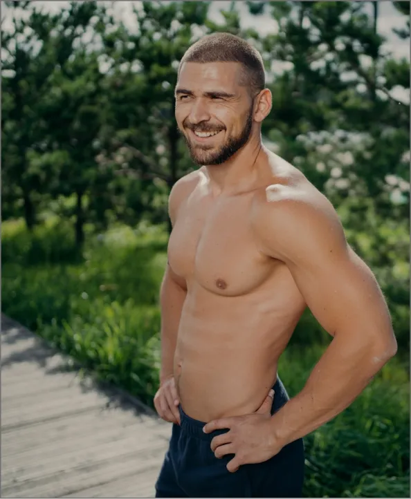 cheerful sporty man works out in nature enjoys at utc