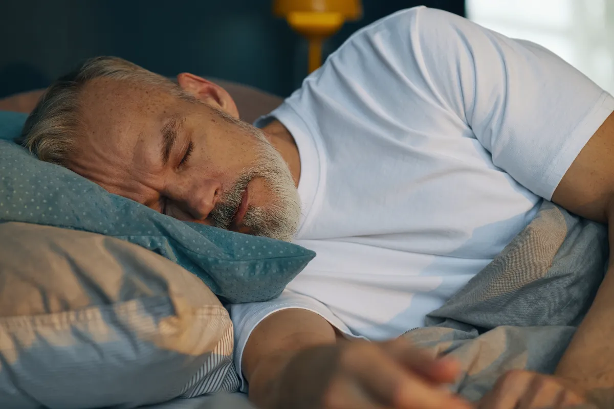 elderly man sleeping peacefully in bed during morn utc