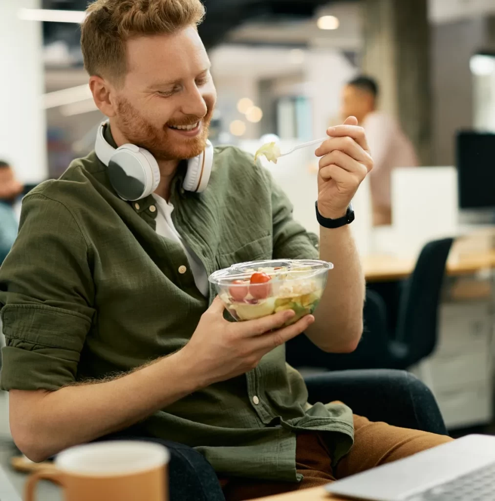 happy businessman eating salad on lunch break in t utc