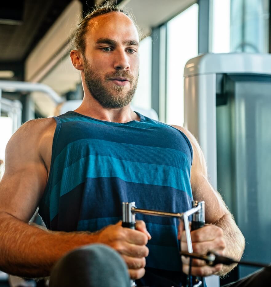 muscular man working out in gym doing exercises to utc jpg