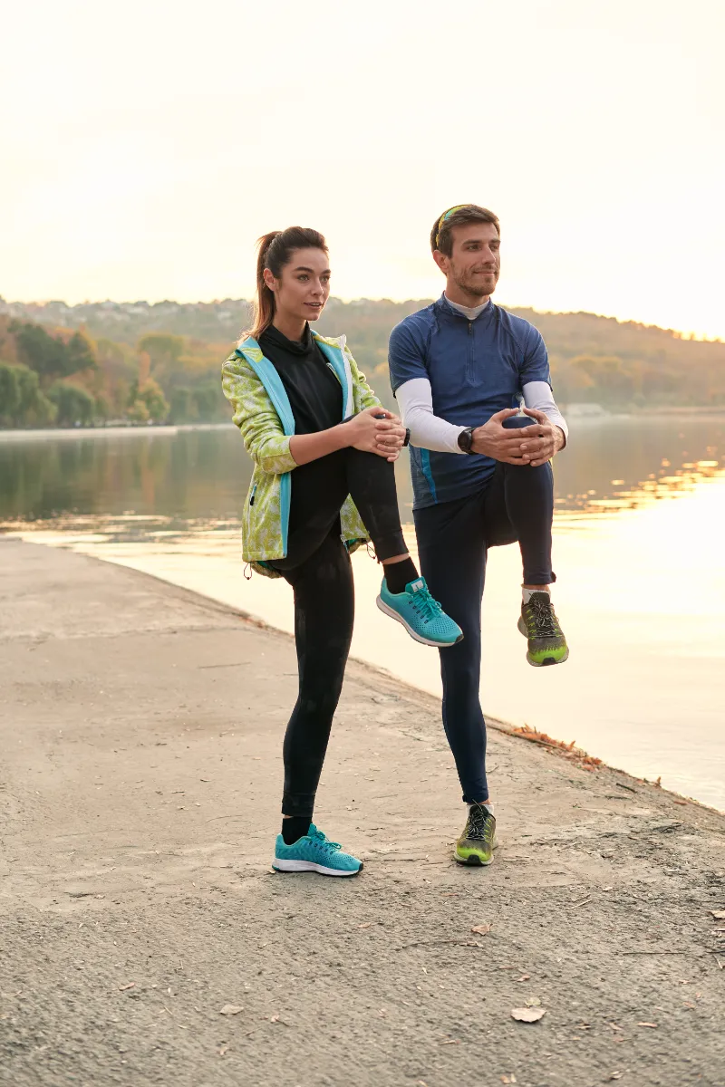young man and woman stretching before running utc