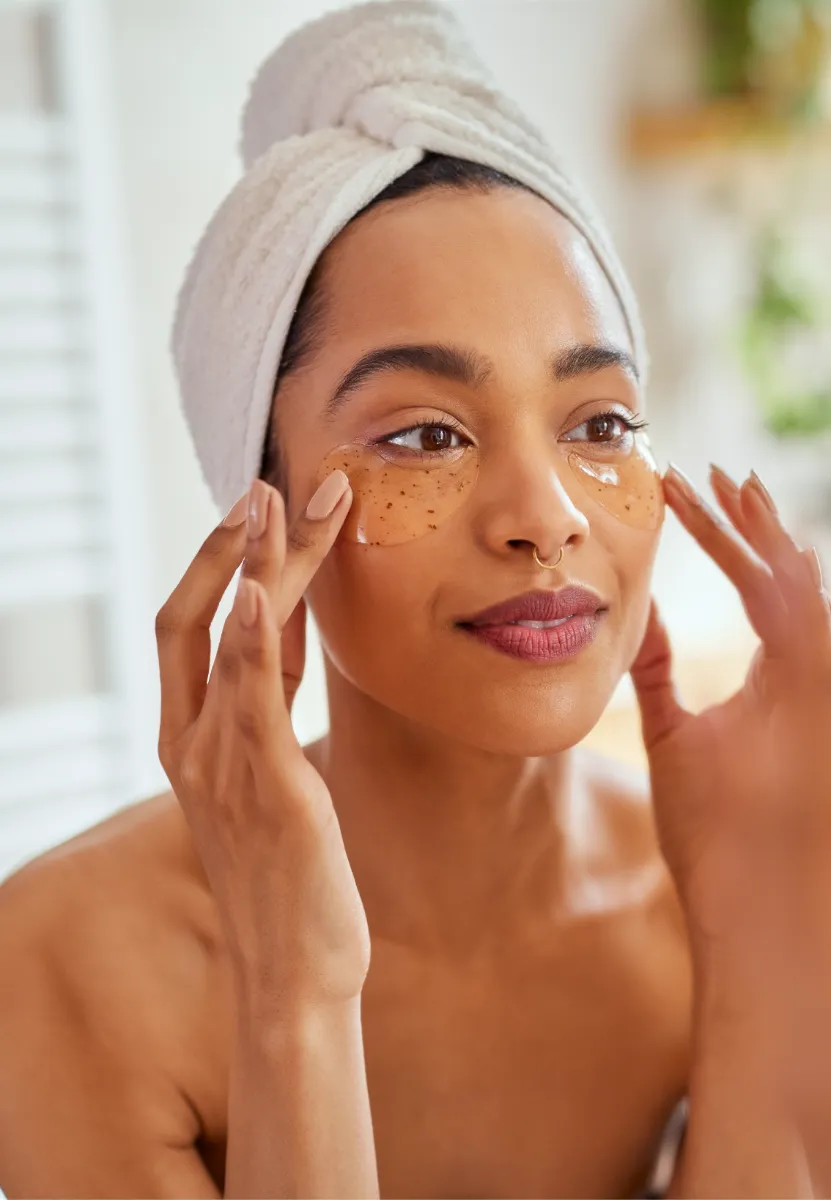 young mixed race woman applying eye patches in bat utc