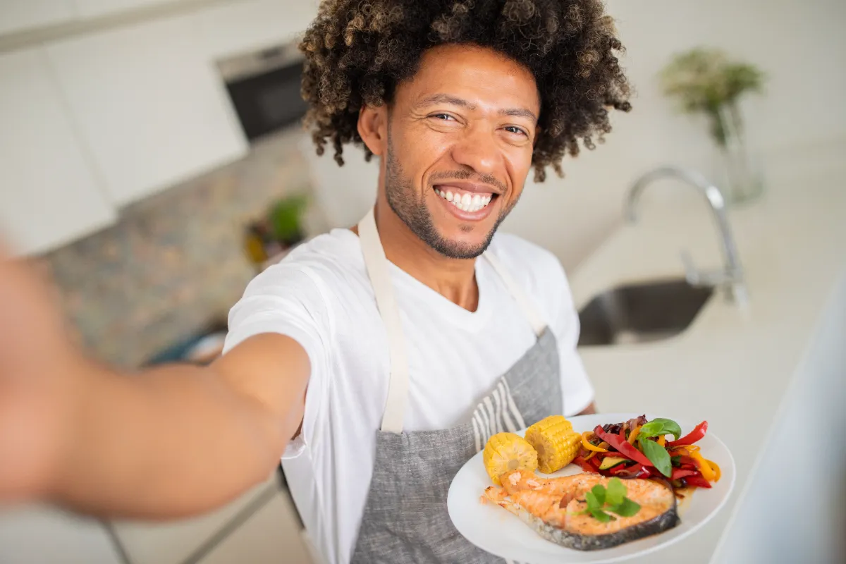 a man proudly presents a delicious homemade meal i utc